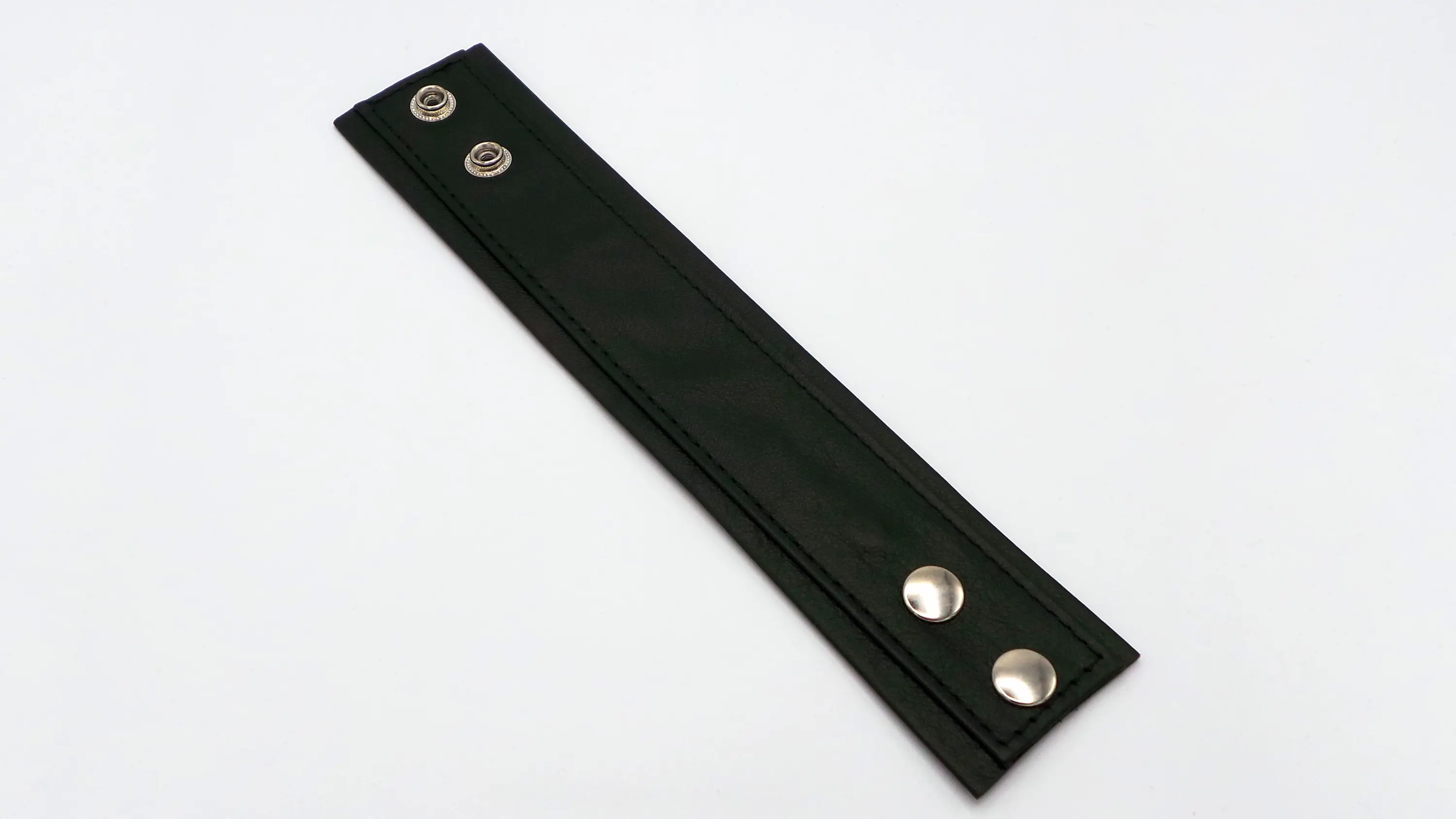 Schwarzes Rindsleder-Armband mit Druckknöpfen, flach aufgeklappt, Außenansicht